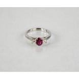 A platinum oval cut ruby, and princess cut diamond trilogy ring, size K, 4.7g.