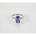 A platinum, sapphire and diamond ring, the emerald cut sapphire 3.70ct, with trapezoid cut diamonds,