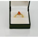 A 9ct gold, diamond and fire opal ring, size N/O, 2.5g.