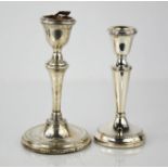 Two silver candlesticks, both with weighted bases, the tallest; Birmingham 1934, 16cm high.