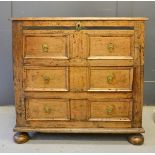 A small 17th century oak mule chest, the dummy drawer above two drawers composed of run moulded