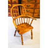 A small mid-19th century Victorian elm wood child’s Windsor arm chair, 13.2 inches high.