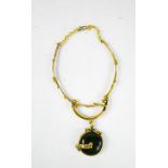 A 1940s gilt metal and green glass necklace.