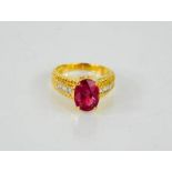 An 18ct gold, diamond and pink ruby oval ring, 8g.