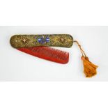 A fine silver and enamelled 19th century folding comb, bearing a tassel.