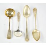 A silver ladle, a serving spoon by Emil Andersen, a white metal soup spoon and a dessert spoon