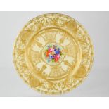 A 19th century Royal Worcester plate decorated with scrollwork, gilding and painted with flowers, by