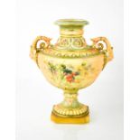 A Royal Worcester urn shaped vase with face mask handles, painted with sprays of flowers, with blush