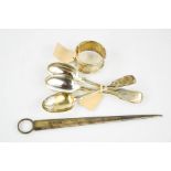 A group of silver to include meat skewer, three matching teaspoons and a napkin ring, 4.63toz.