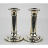 A pair of silver candlesticks hallmarked Birmingham - 13.5cm - 18toz weighted bases