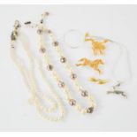 Two pearl necklaces, a frog brooch and a horse brooch