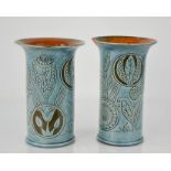 A pair of CH Brannam Barum Art Nouveau vases, with pale blue glaze, incised with decoration, one A/