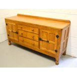 A Robert Thompson 'Mouseman' oak sideboard, the galleried back adjoining to an adzed top and three