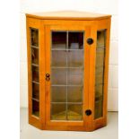 A Robert Thompson 'Mouseman' panelled hanging corner cupboard, with three interior shelves, brush