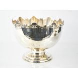 A silver punch bowl, with scalloped edge and shell pattern, Birmingham 1908, retailed by TW Long Co,