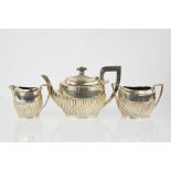 A three piece silver tea service, comprising tea pot, sugar bowl and milk jug, London 1899, 27toz.