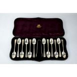 A cased set of twelve silver teaspoons and a pair of sugar nips by Hamilton & Inches Edinburgh