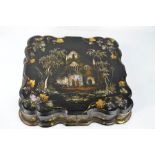 A 19th century papier mache and mother of pearl inlaid box, the lid depicting a church and enclosing