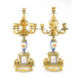 A 19th century pair of candelabras with five gilt sconces with porcelain panels with a blue ground