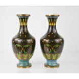 A pair of black ground Cloisonne baluster vases, with turquoise base and polychrome stylised foliate