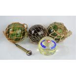 Three antique green glass fishing floats together with a Murano glass paperweight
