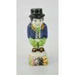 A rare late 18th century Dutch polychrome castor in the form of a man having a poo, 11cm high.