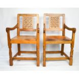 A pair of Robert Thompson 'Mouseman' of Kilburn open armchairs, with lattice backs, original leather