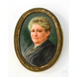 A 19th century miniature portrait of a woman wearing black, in an oval frame.