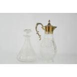 A cut glass decanter and a claret jug.