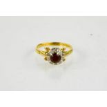 An 18ct gold, garnet and diamond ring, 4.8g.