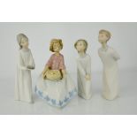 A Nao Lladro girl holding a cake, and three Lladro children in night dresses.