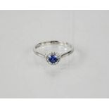 A 9ct white gold sapphire and diamond halo ring, size M, 1.6g.