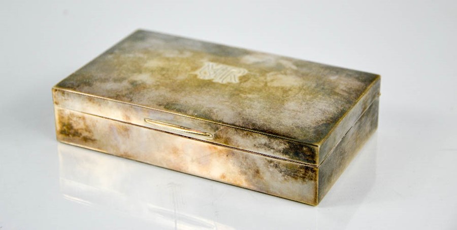 A silver cigarette box, with cedar lined interior, monogrammed to the top MRH.