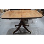 A 19th century single pedestal mahogany dining table together extra leaf