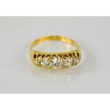 An 18ct diamond five stone ring, composed of graduated old cut diamonds, in an Edwardian setting,