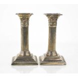 A pair of silver corinthian column form candlesticks, Birmingham 1905, 14cm high.