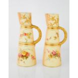 A pair of Royal Worcester blush ivory jugs painted with flowers and raised gilding, 23cm high.