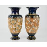 A pair of Doulton vases, with dark blue mottled ground, raised scrolls and gilded highlights, 30cm