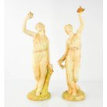 A pair of Royal Worcester figurines in blush ivory, the figures holding doves aloft, date code to