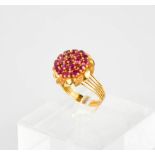 A 9ct (tested) gold and pink sapphire cluster ring, flower head form, 6g.