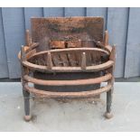 An antique cast iron fire grate with ball form feet, 47cm by 46cm.