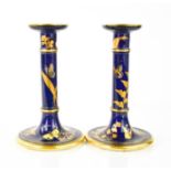 A pair of Royal Worcester candle sticks, circa 1900, decorated with butterflies, and insects with