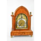 An Edwardian mahogany and satinwood inlaid arched mantle clock with Roman numerals, an eight day