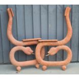 A pair of cast iron bench ends in the form of snakes, 84cm high.
