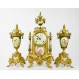 A 20th century French clock garniture, with porcelain panels depicting figures in landscape and