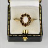 A 9ct gold, opal and garnet flowerhead ring, size O, 5.4g.