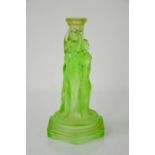 A Walther Sohne green vaseline glass candlestick, modelled with the three graces.