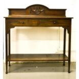 A 19th century mahogany side table with two drawers, raised carved back with under-tier, stamped