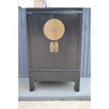 A large Chinese black lacquered stacking chest on chest.