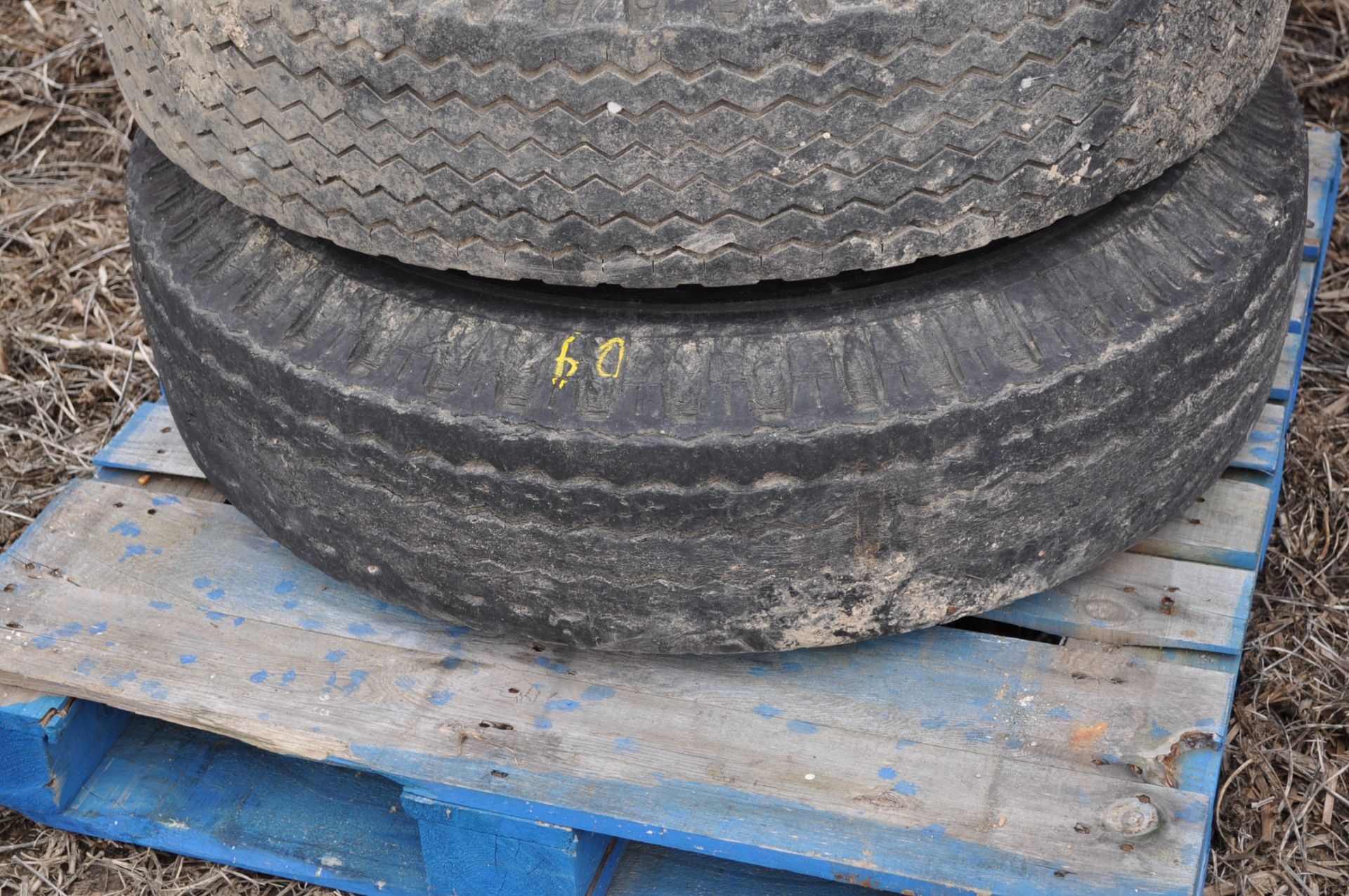 Spare 11R22.5 tire on rim for gravity wagon